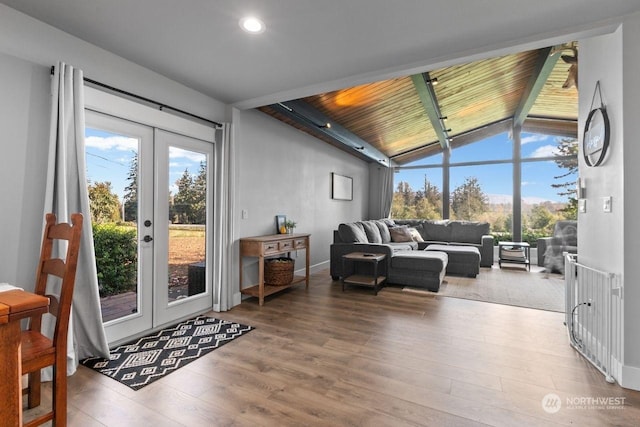 living room featuring vaulted ceiling, french doors, and wood-type flooring