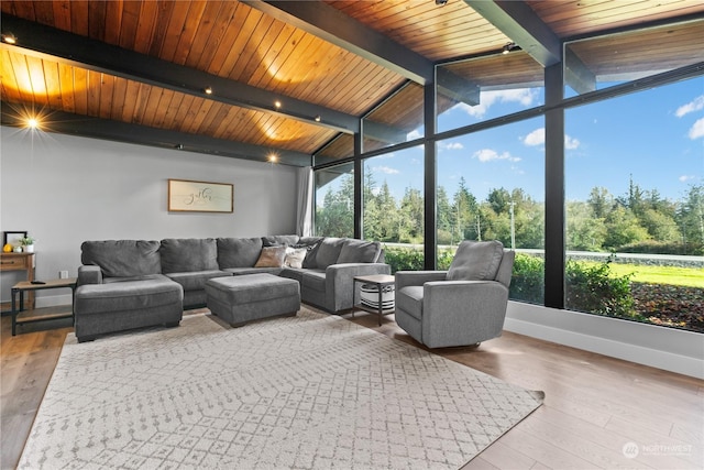 sunroom / solarium featuring vaulted ceiling with beams and wooden ceiling