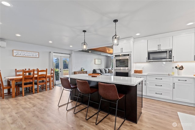 kitchen featuring white cabinetry, appliances with stainless steel finishes, and a kitchen island