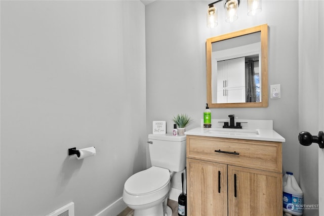 bathroom with toilet and vanity