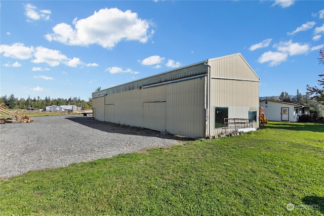 view of outbuilding featuring a yard