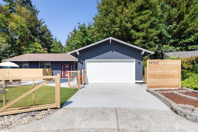 ranch-style house with a garage and a front lawn