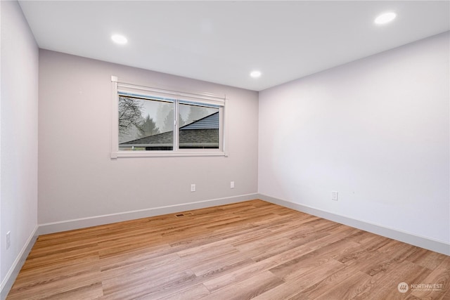 spare room featuring light hardwood / wood-style floors