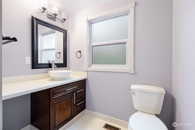 bathroom with toilet and vanity