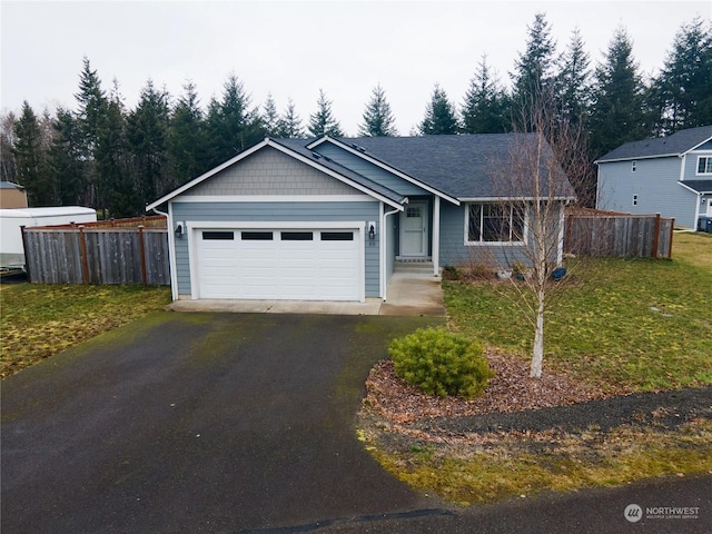 view of front of home featuring a garage and a front lawn