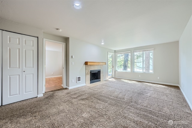 unfurnished living room with carpet and a fireplace