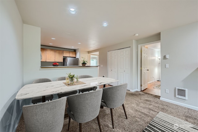 dining room with light colored carpet