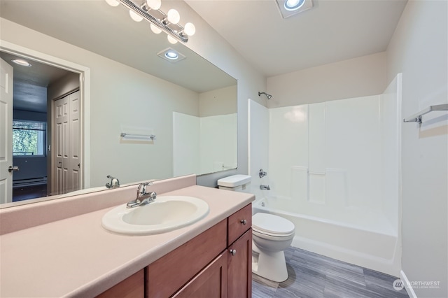 full bathroom featuring hardwood / wood-style flooring, shower / bath combination, toilet, and vanity