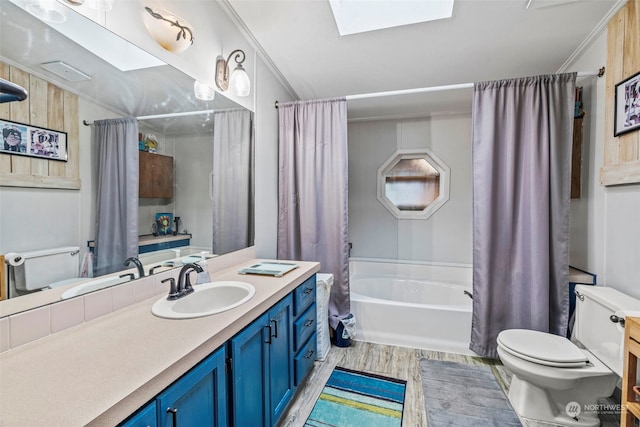 full bathroom featuring shower / tub combo, hardwood / wood-style floors, a skylight, vanity, and toilet