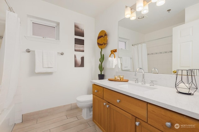 bathroom with toilet and vanity