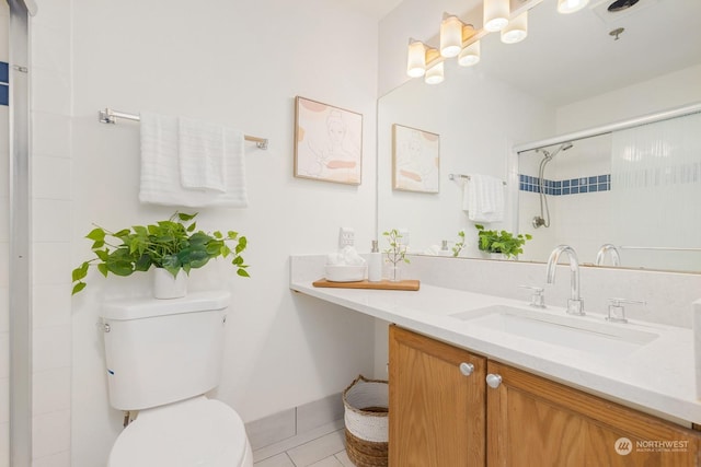 bathroom featuring vanity, toilet, walk in shower, and tile patterned floors