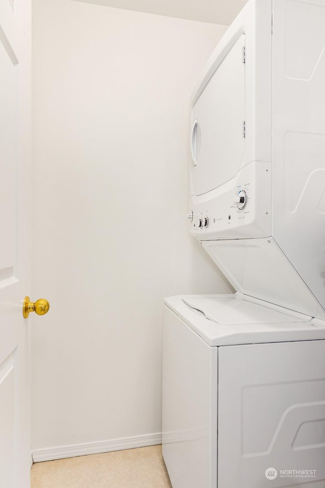 clothes washing area with stacked washer / drying machine