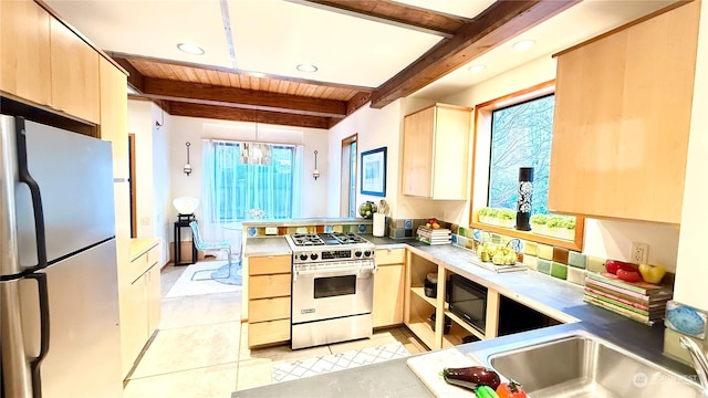 kitchen with light brown cabinetry, appliances with stainless steel finishes, and beam ceiling