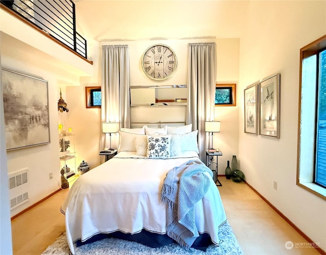 bedroom featuring light wood-type flooring and radiator heating unit