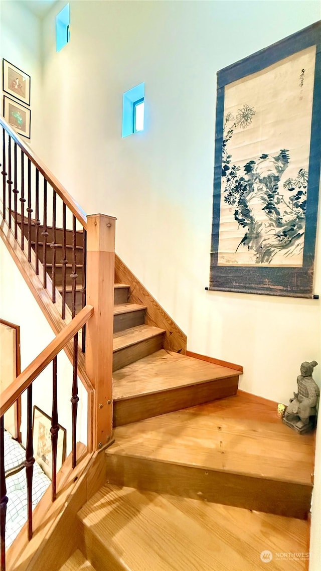 stairs with hardwood / wood-style floors