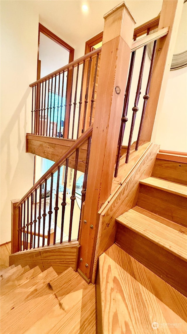 stairway featuring wood-type flooring