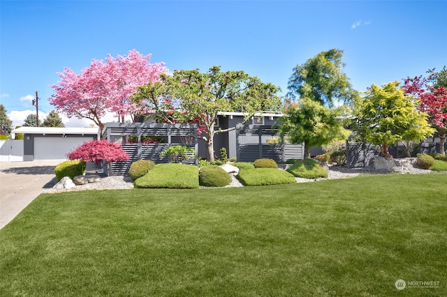 view of front of home featuring a garage and a front lawn