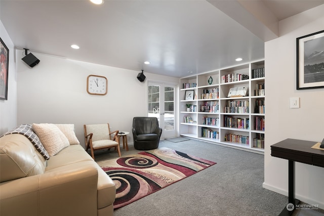 living room with built in features, french doors, and carpet flooring