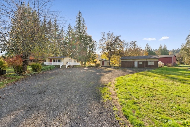 view of front of home featuring a front yard and a storage unit