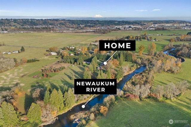 birds eye view of property featuring a water view and a rural view