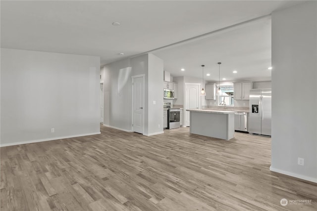 unfurnished living room featuring light wood-type flooring