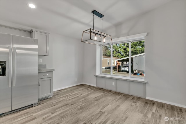 unfurnished dining area with light hardwood / wood-style flooring