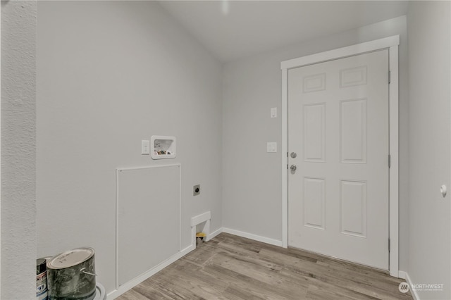 laundry area with hookup for a washing machine, light hardwood / wood-style flooring, and electric dryer hookup