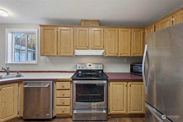 kitchen featuring tile patterned flooring, sink, and appliances with stainless steel finishes