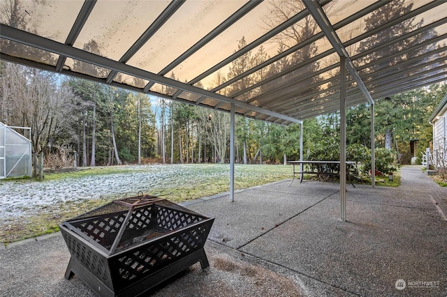 view of patio with an outdoor fire pit and an outdoor structure