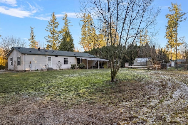 exterior space with an outdoor structure and a lawn