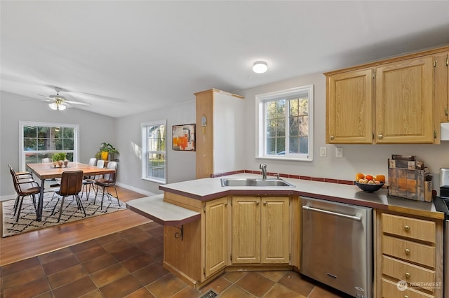 kitchen with sink, ceiling fan, dishwasher, vaulted ceiling, and light brown cabinets