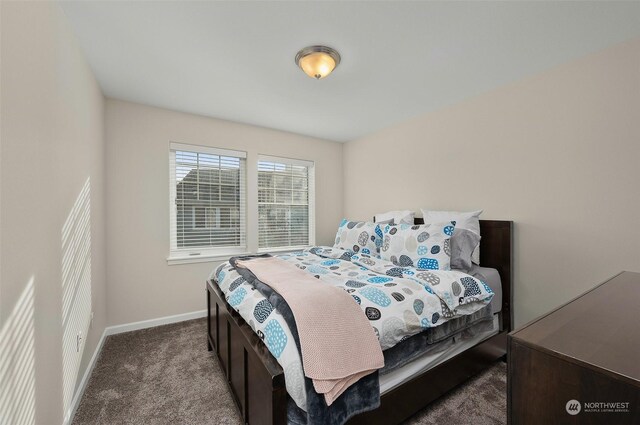 bedroom with dark colored carpet