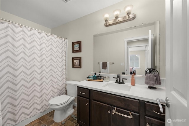 bathroom with toilet, a shower with shower curtain, and vanity