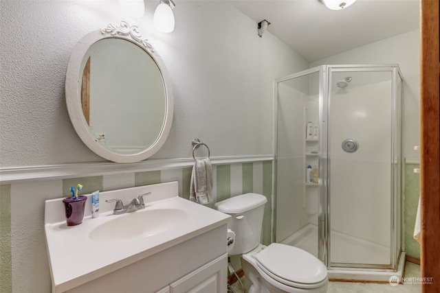 bathroom featuring lofted ceiling, vanity, toilet, and an enclosed shower