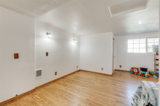 rec room with hardwood / wood-style flooring and a textured ceiling