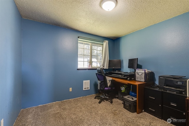 office space featuring carpet and a textured ceiling