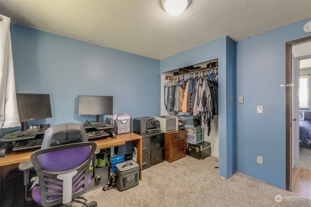 office with carpet floors and a textured ceiling