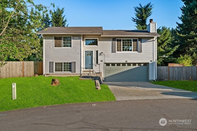 raised ranch with a garage and a front yard