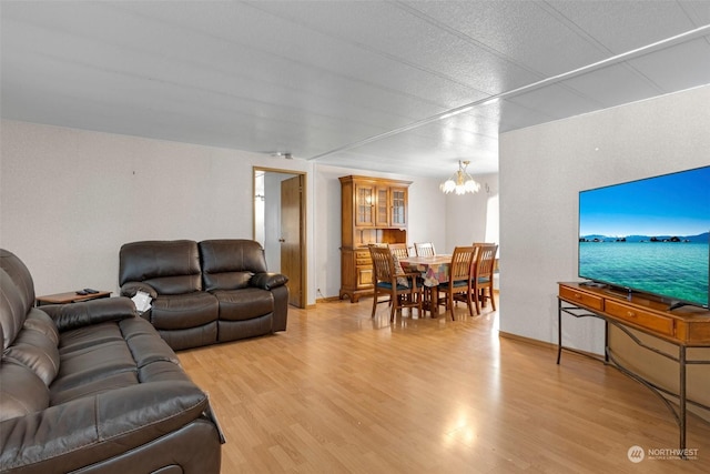 living room featuring light hardwood / wood-style flooring and a notable chandelier