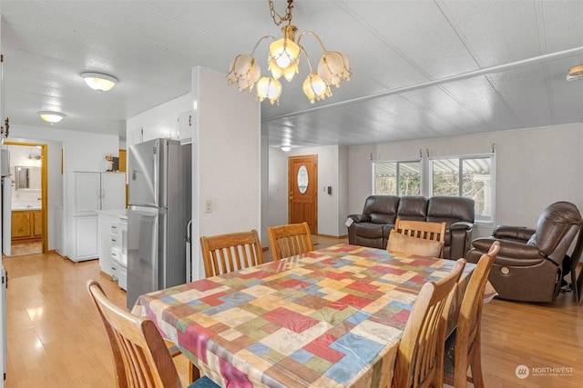 dining room featuring a chandelier and light hardwood / wood-style flooring