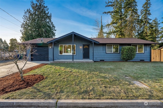 ranch-style home featuring a garage and a front lawn