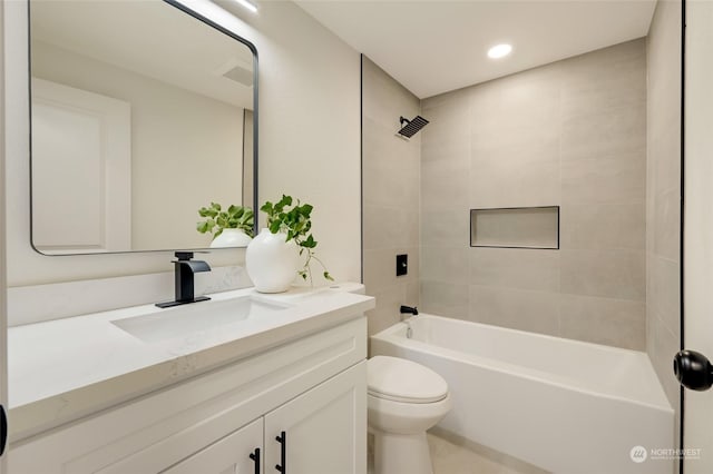 full bathroom with vanity, toilet, and tiled shower / bath combo