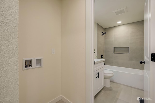 full bathroom with toilet, vanity, tiled shower / bath combo, and tile patterned flooring