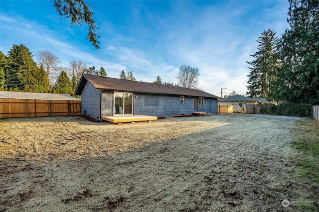 back of house with a wooden deck