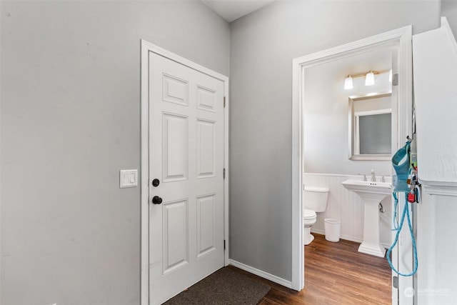 bathroom with hardwood / wood-style flooring, sink, and toilet