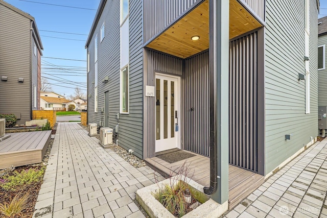 property entrance with ac unit and a patio area