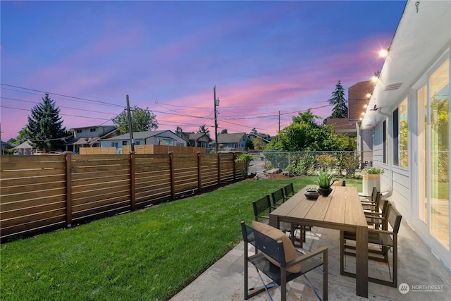 yard at dusk with a patio area