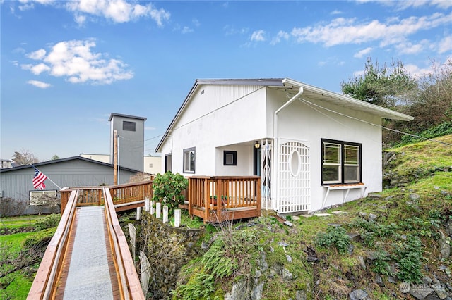 back of house featuring a wooden deck