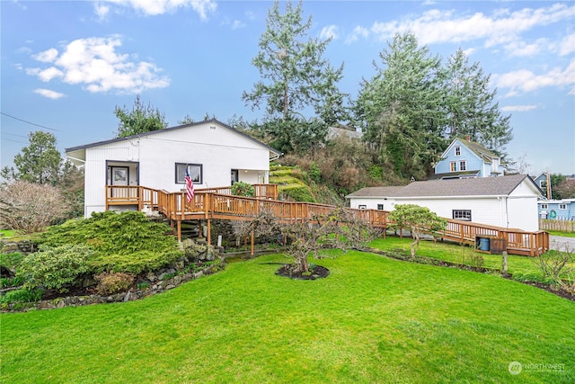 back of property with a lawn and a wooden deck