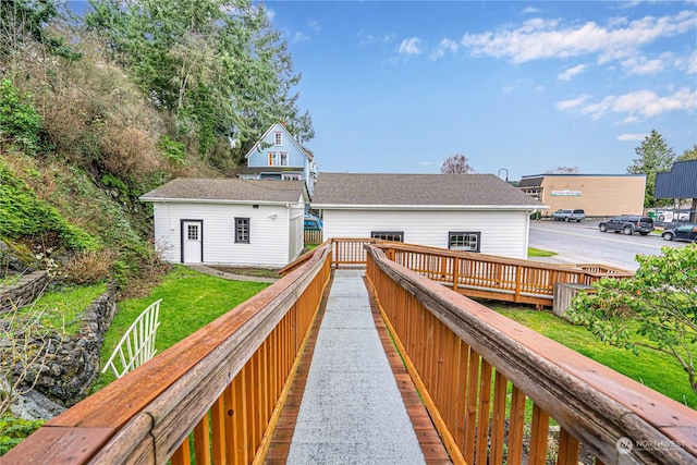 back of property with a deck and an outbuilding